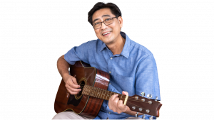 man playing guitar smiling