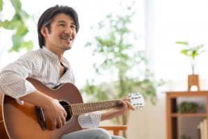 Happy man playing a guitar