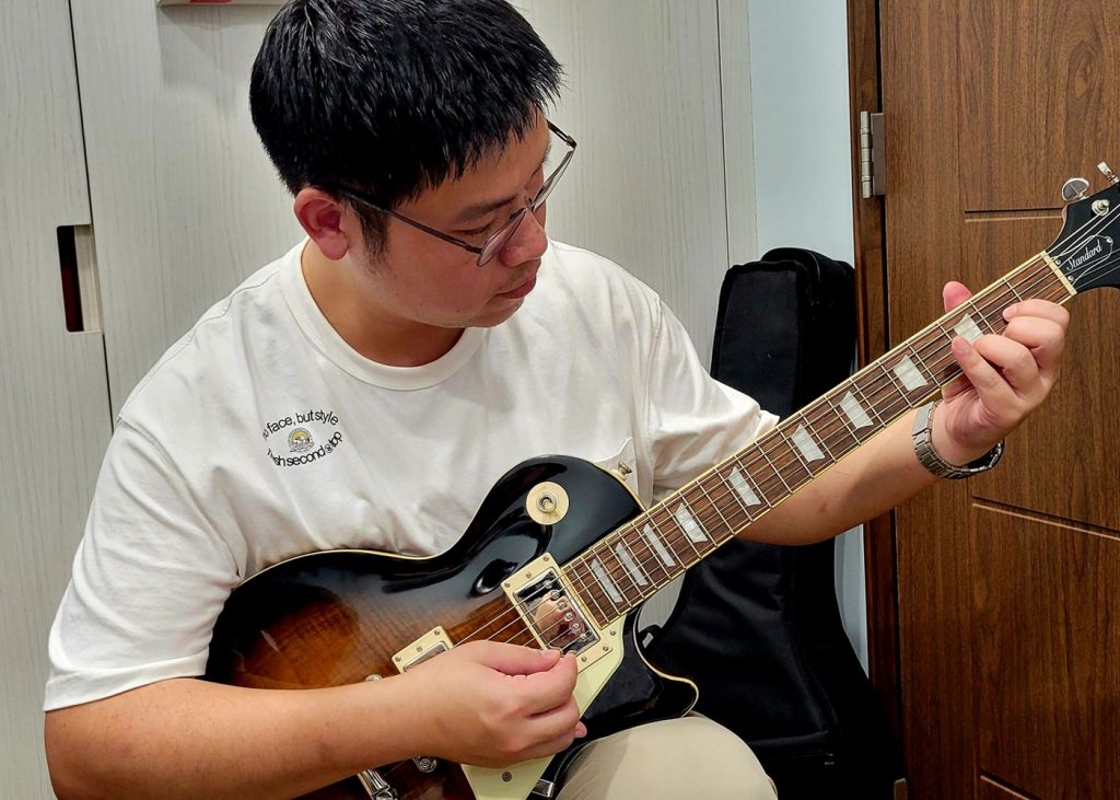 Student Playing Guitar