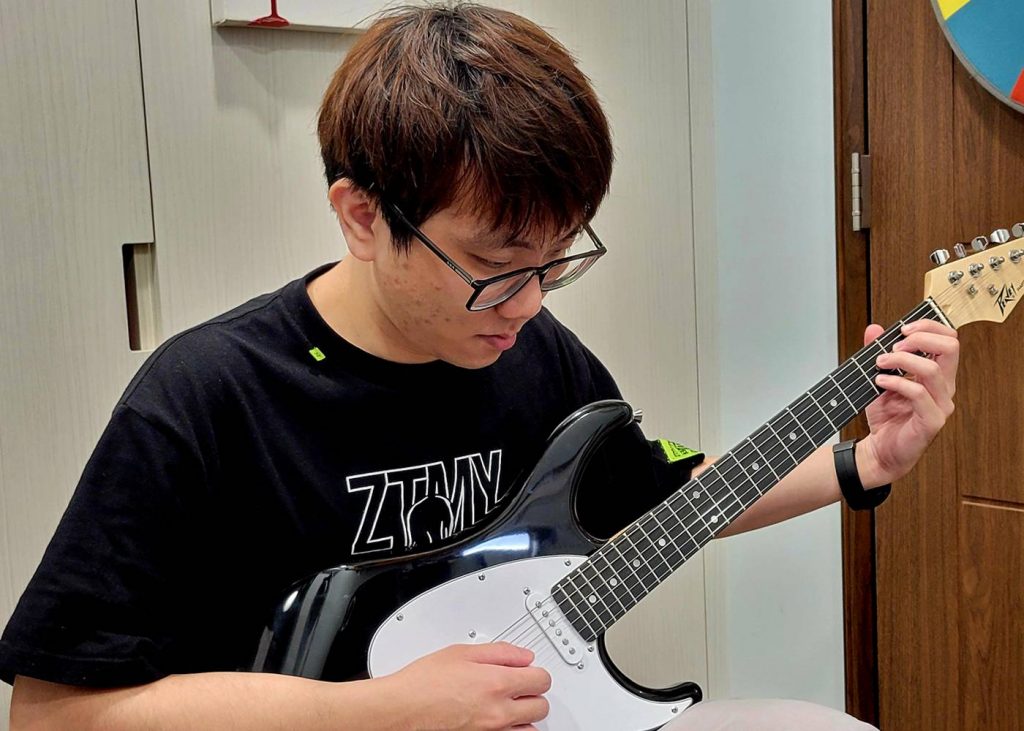 Student Playing Guitar