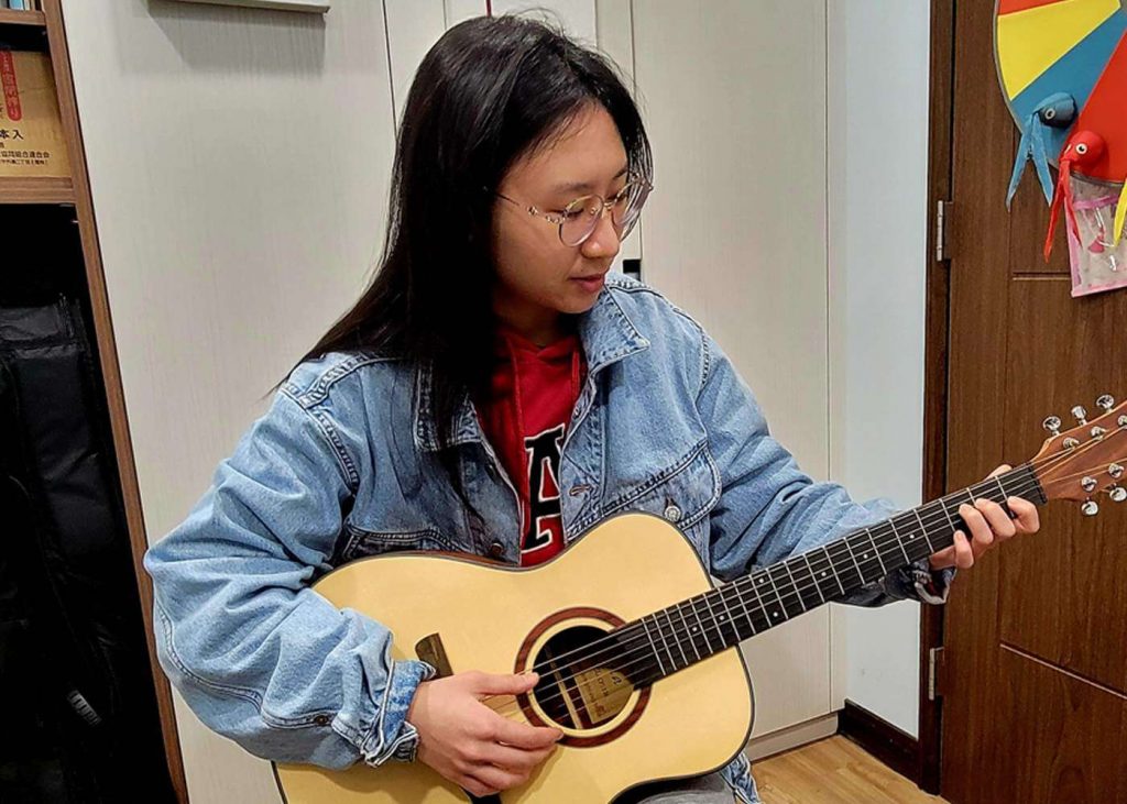 Happy Student Playing Guitar
